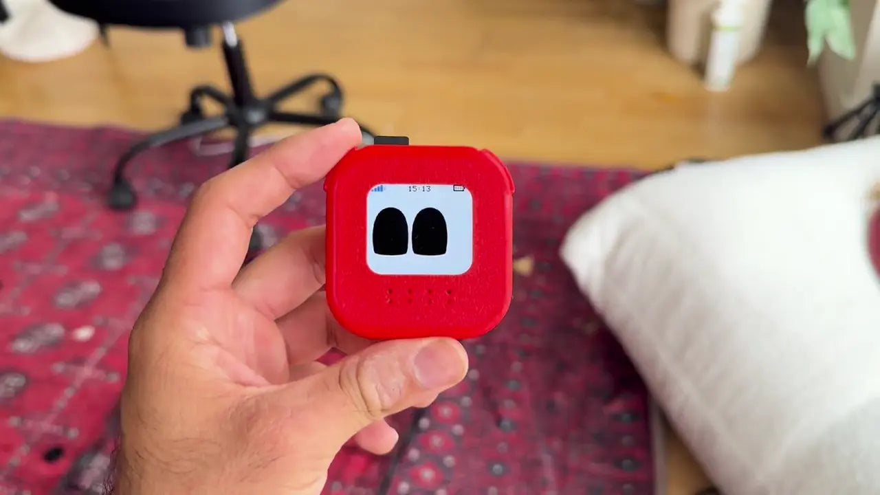 A red Kami-Ø prototype held in one hand